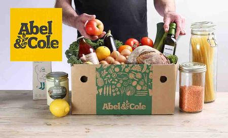 Abel & Cole logo placed over an image of a man with a food box