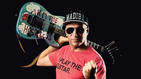 Tom Morello poses with his Arm The Homeless guitar