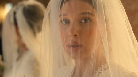 Millie Bobby Brown in Enola Holmes 3 with a wedding veil over her face
