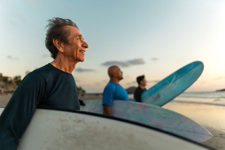 Senior surfer man contemplating on the beach