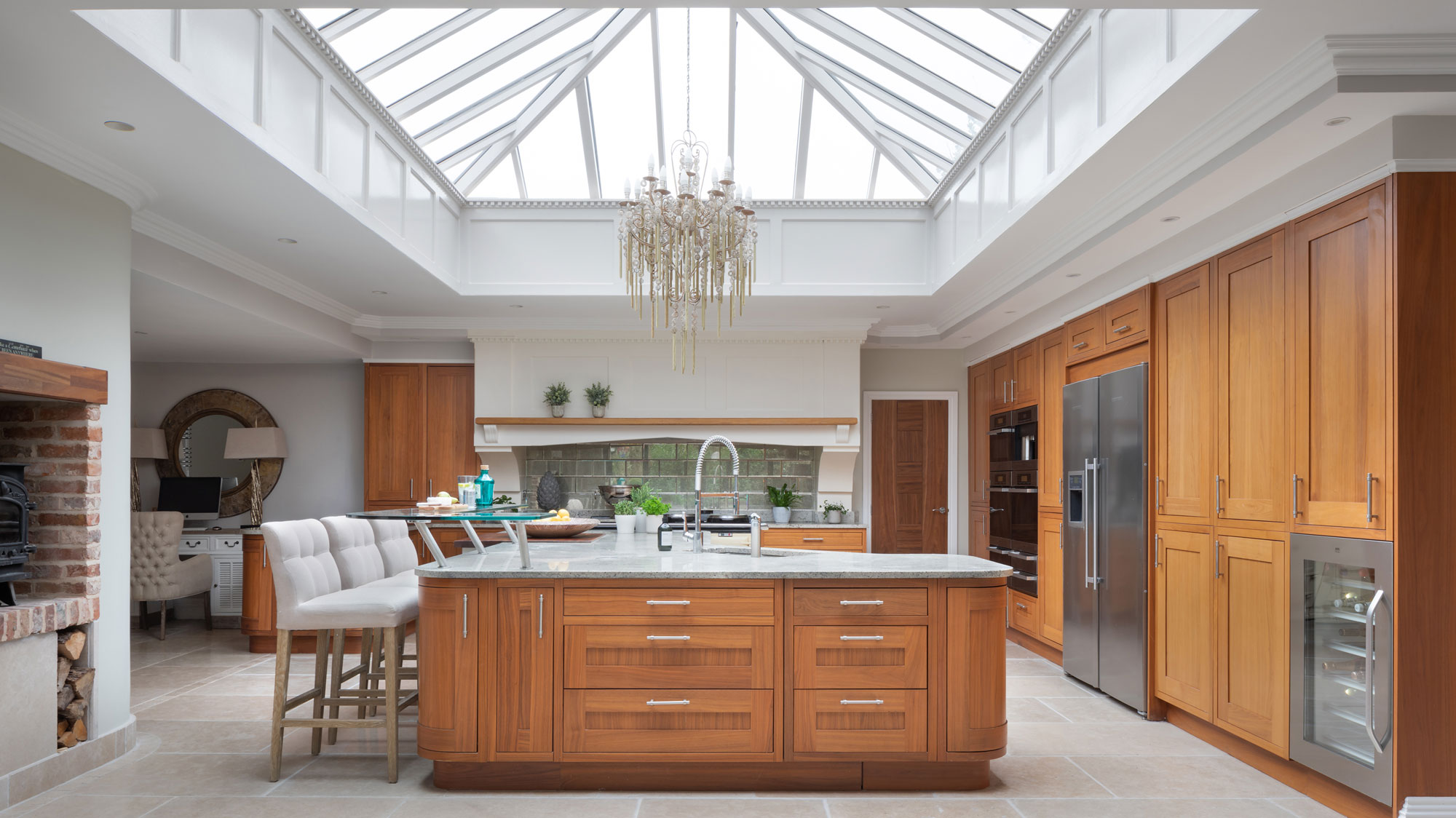 large wooden kitchen with large kitchen island with roof lantern above