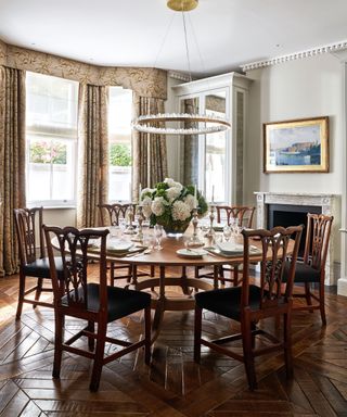 Dining room with large round table and wood floor