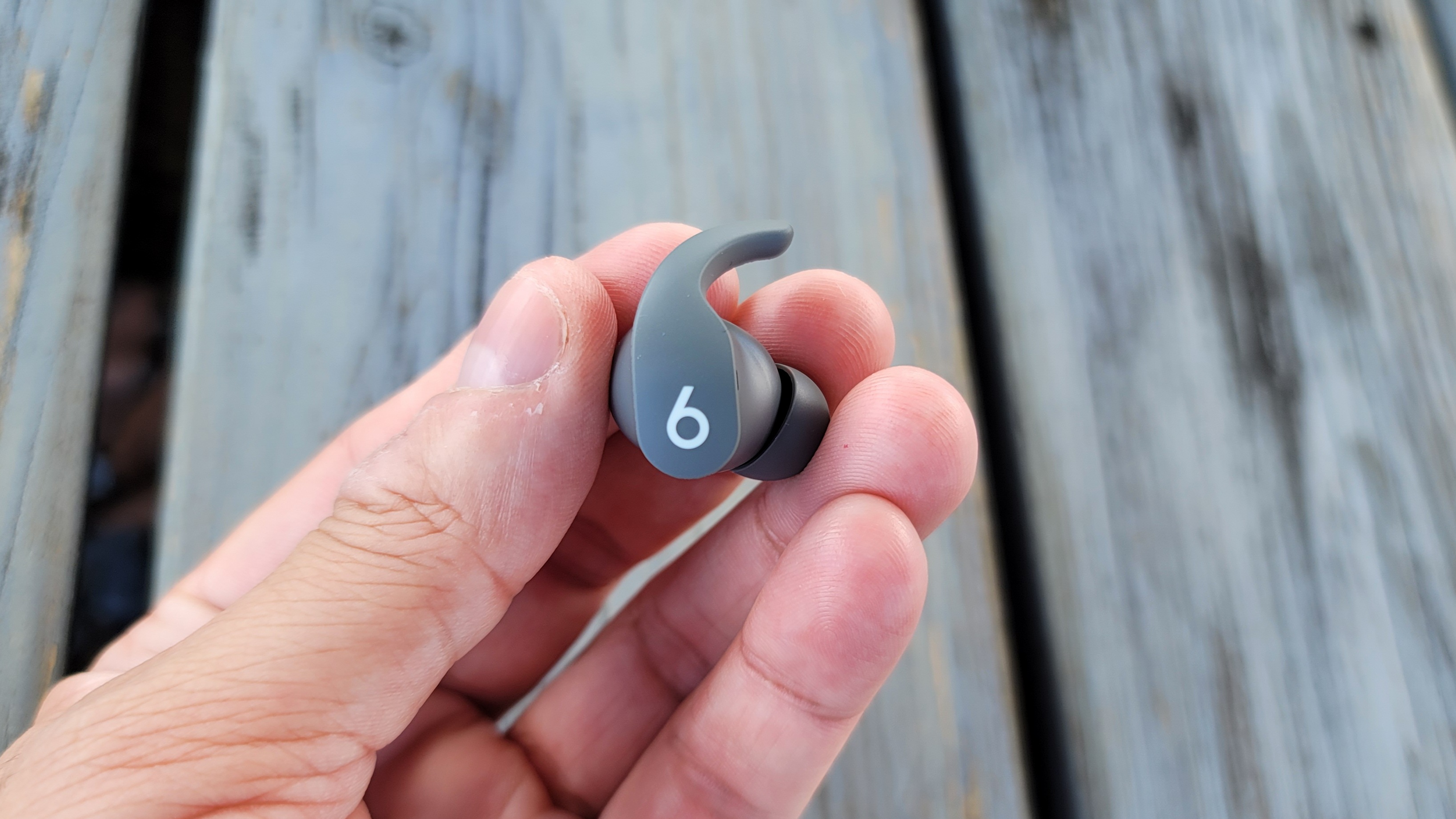 The Beats Fit Pro's multifunctional button being shown