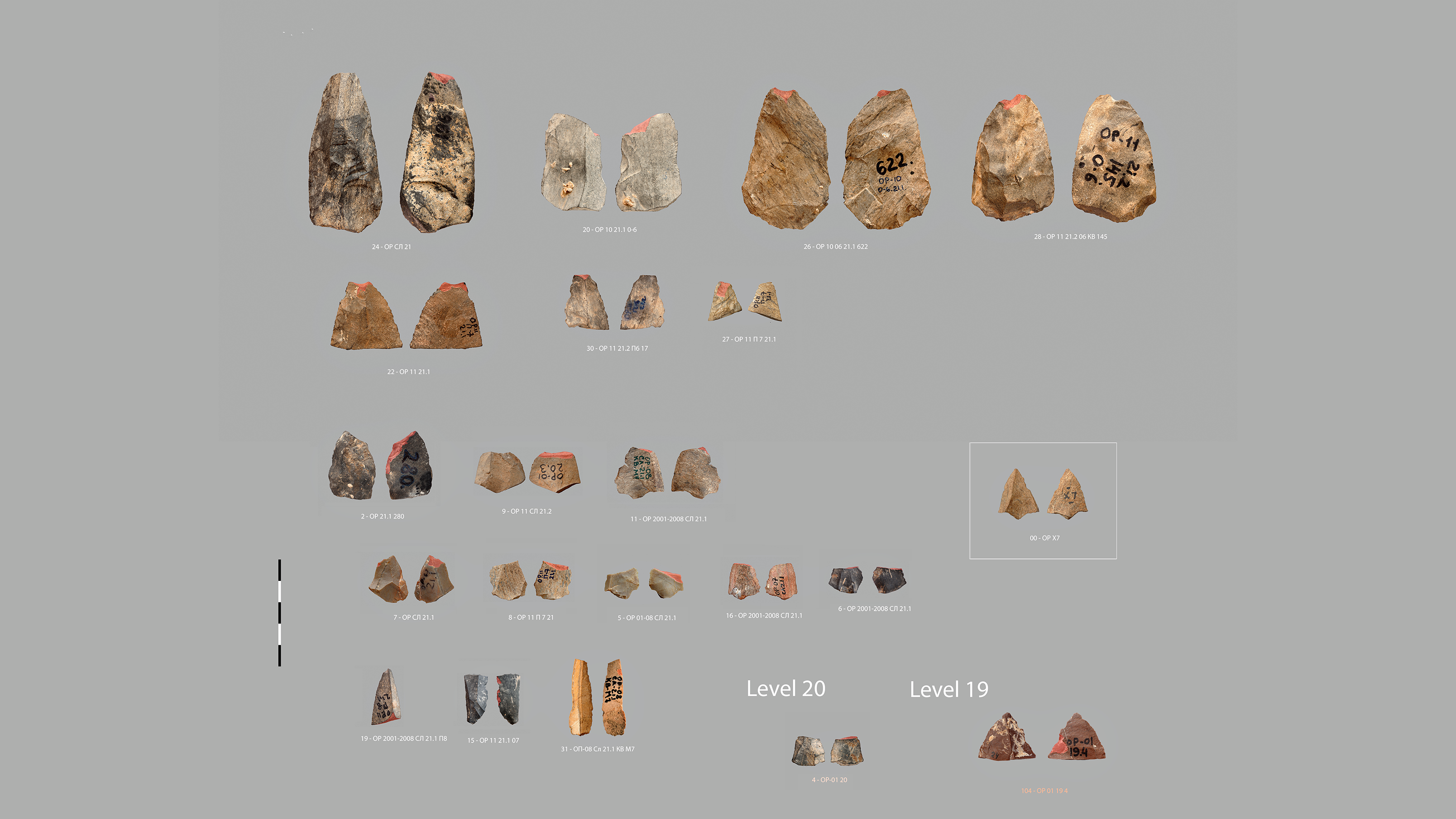 a series of small, orange-colored stone points against a grey background