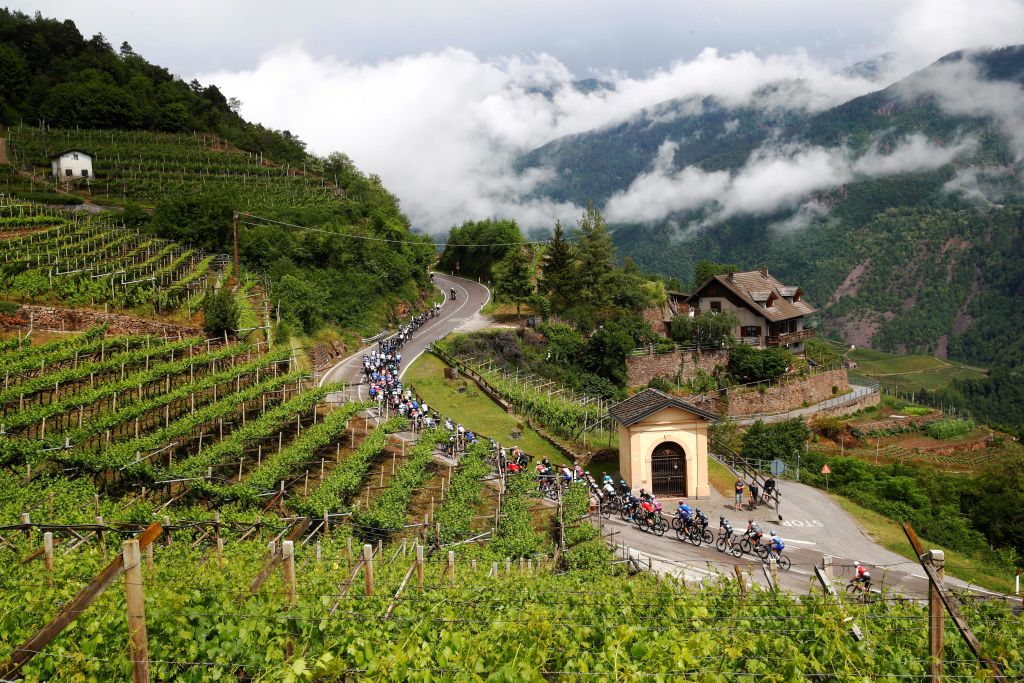 TOPSHOT The pack rides near Lisignago village during the 17th stage of the Giro dItalia 2022 cycling race 168 kilometers from Ponte di Legno to Lavarone on May 25 2022 Photo by Luca Bettini AFP Photo by LUCA BETTINIAFP via Getty Images