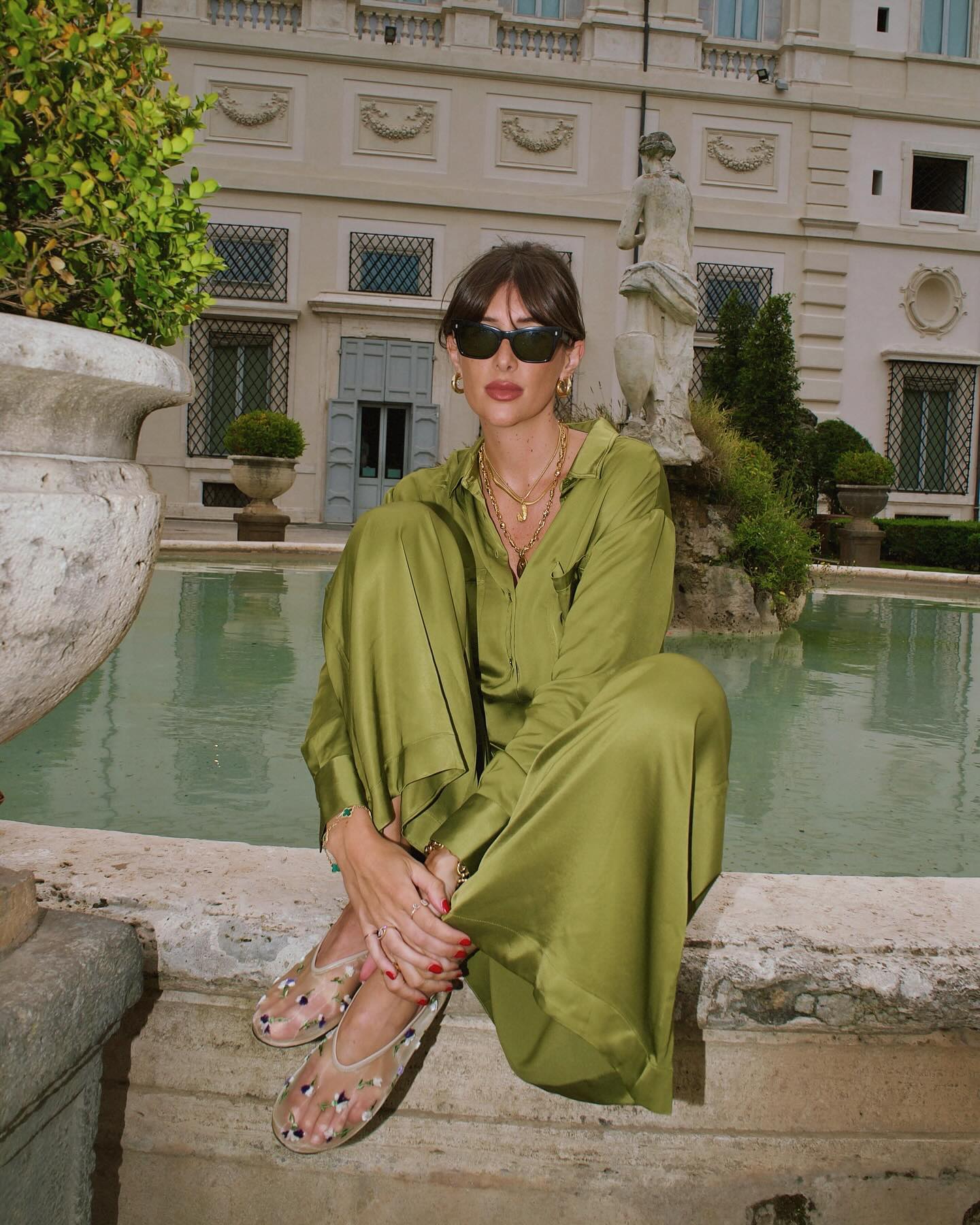 @juliesfi outfit picture in green silky set and Khaite mesh flats.