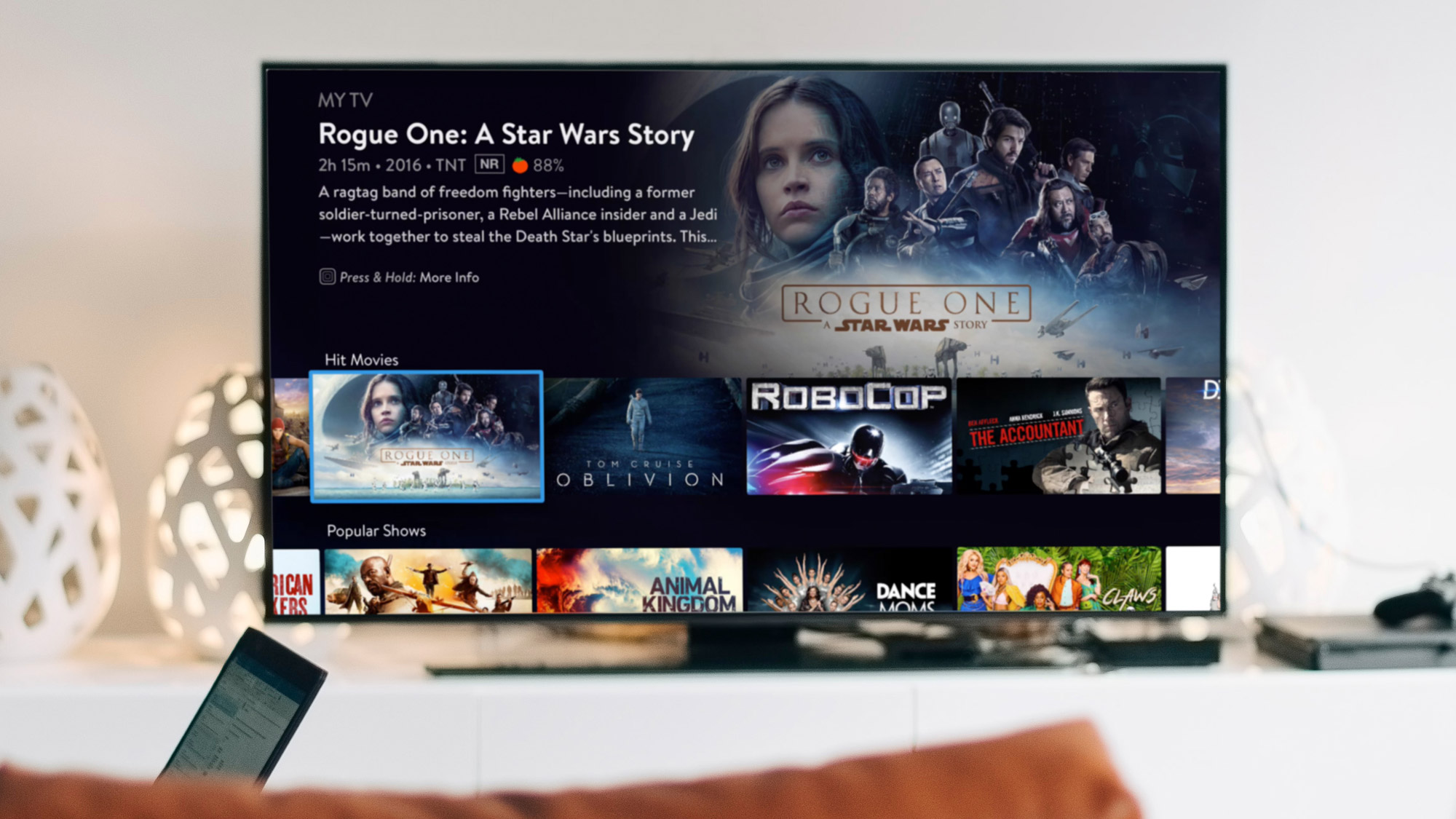 Sling TV, navigated to Rogue One A Star Wars Story, on a TV in a living room