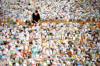 Tom Moore received more than 125,000 birthday cards - pictured lined up on the floor