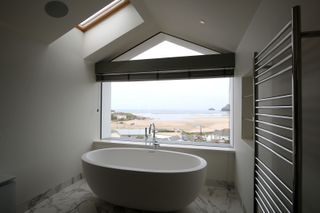 a bathroom picture window with a venetian blind