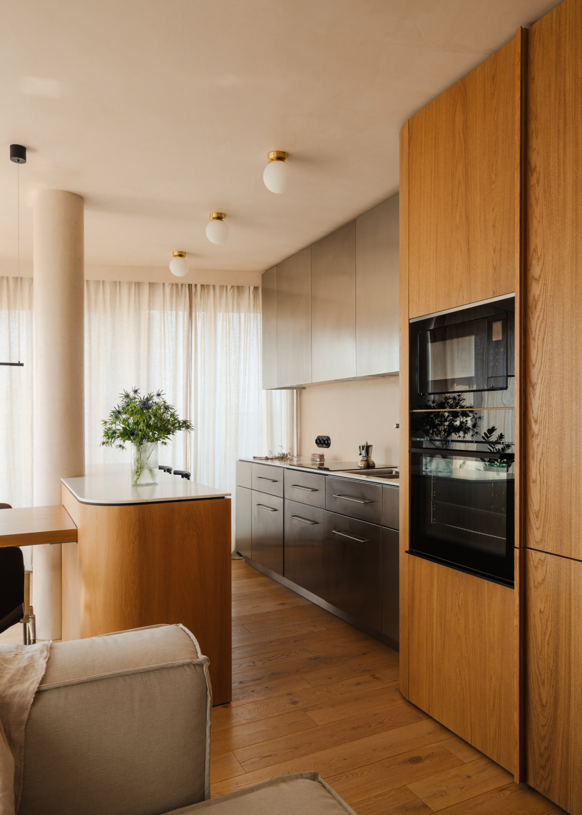 wooden and steel modern kitchen design with curved edge kitchen island