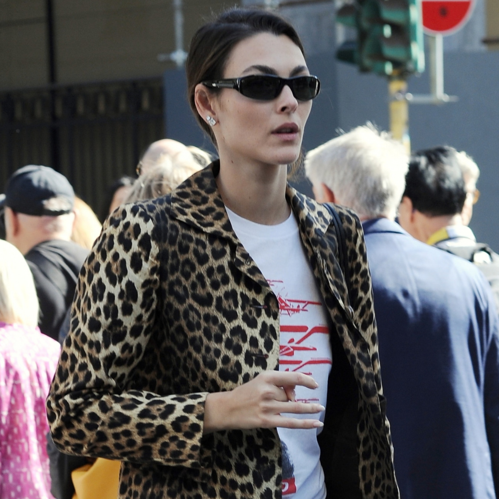 Vittoria Ceretti photographed in Milan between shows during Milan Fashion Week wearing Prada Montecarlo Re-Edition 2005 Suede-Trimmed Mesh Sneakers in yellow.