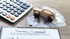 Vehicle insurance claim form, calculator and money.