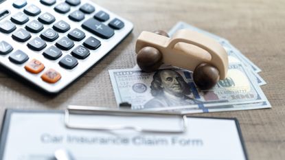 Vehicle insurance claim form, calculator and money.