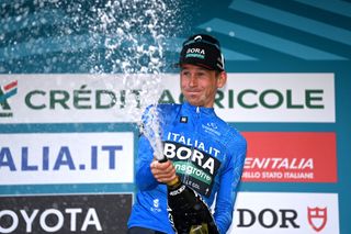 TORTORETO ITALY MARCH 09 Lennard Kmna of Germany and Team BORA Hansgrohe celebrates at podium as Blue Leader Jersey winner during the 58th TirrenoAdriatico 2023 Stage 4 a 218km stage from Greccio to Tortoreto 229m UCIWT TirrenoAdriatico on March 09 2023 in Tortoreto Italy Photo by Tim de WaeleGetty Images