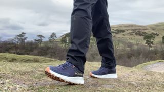 A hiker's feet wearing the Columbia Konos TRS Outdry shoes