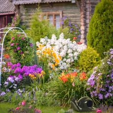 A beautiful ornamental garden with cutout of ceramic snail trap layered on top.