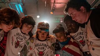 A group of kids gathered around a table during the Netflix show Stranger Things.