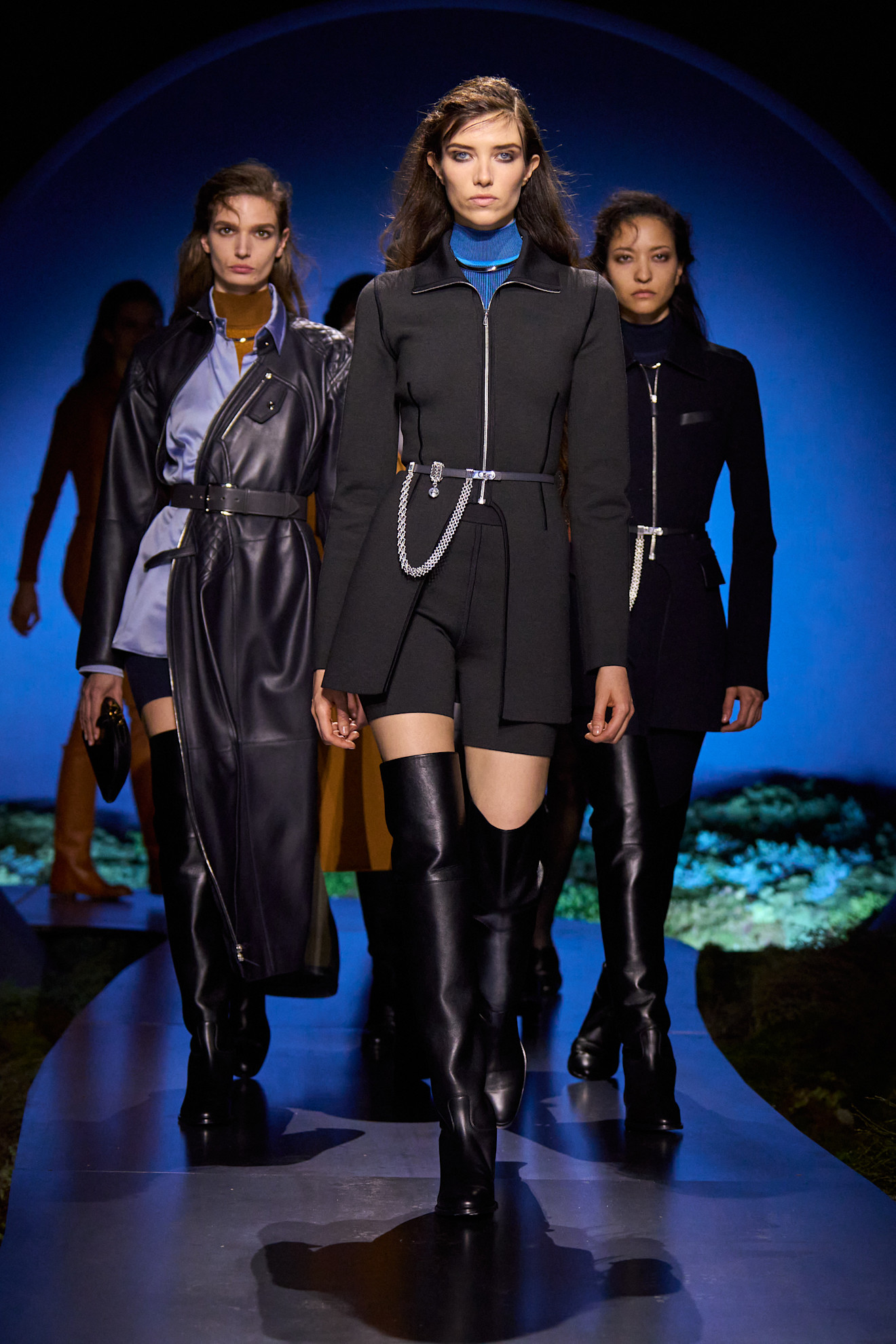 three models on the Hermes fall 2026 runway wearing thigh high leather boots