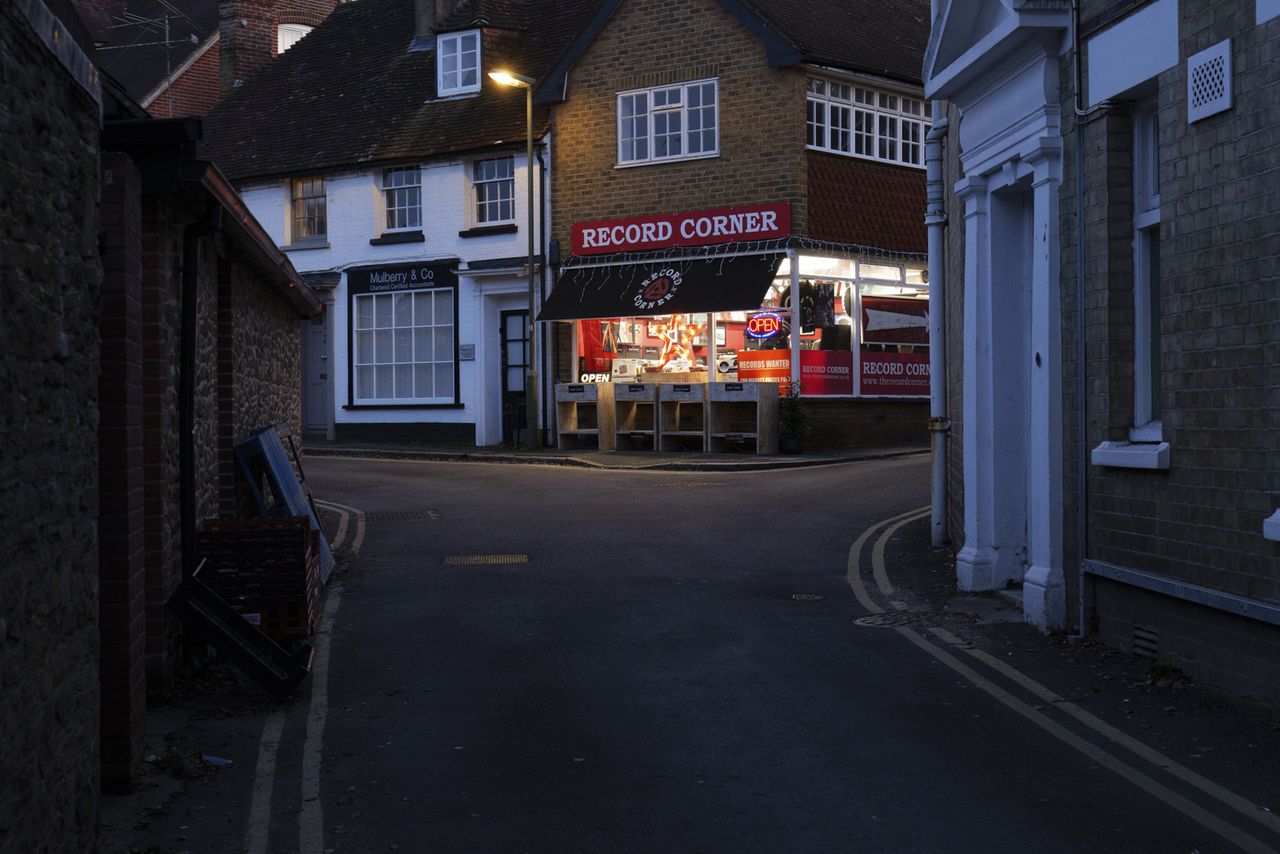 Picture taken with Panasonic S5 II of record shop on street corner at night