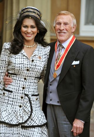 Sir Bruce Forsyth with his wife Wilnelia after being knighted by Queen Elizabeth II.
