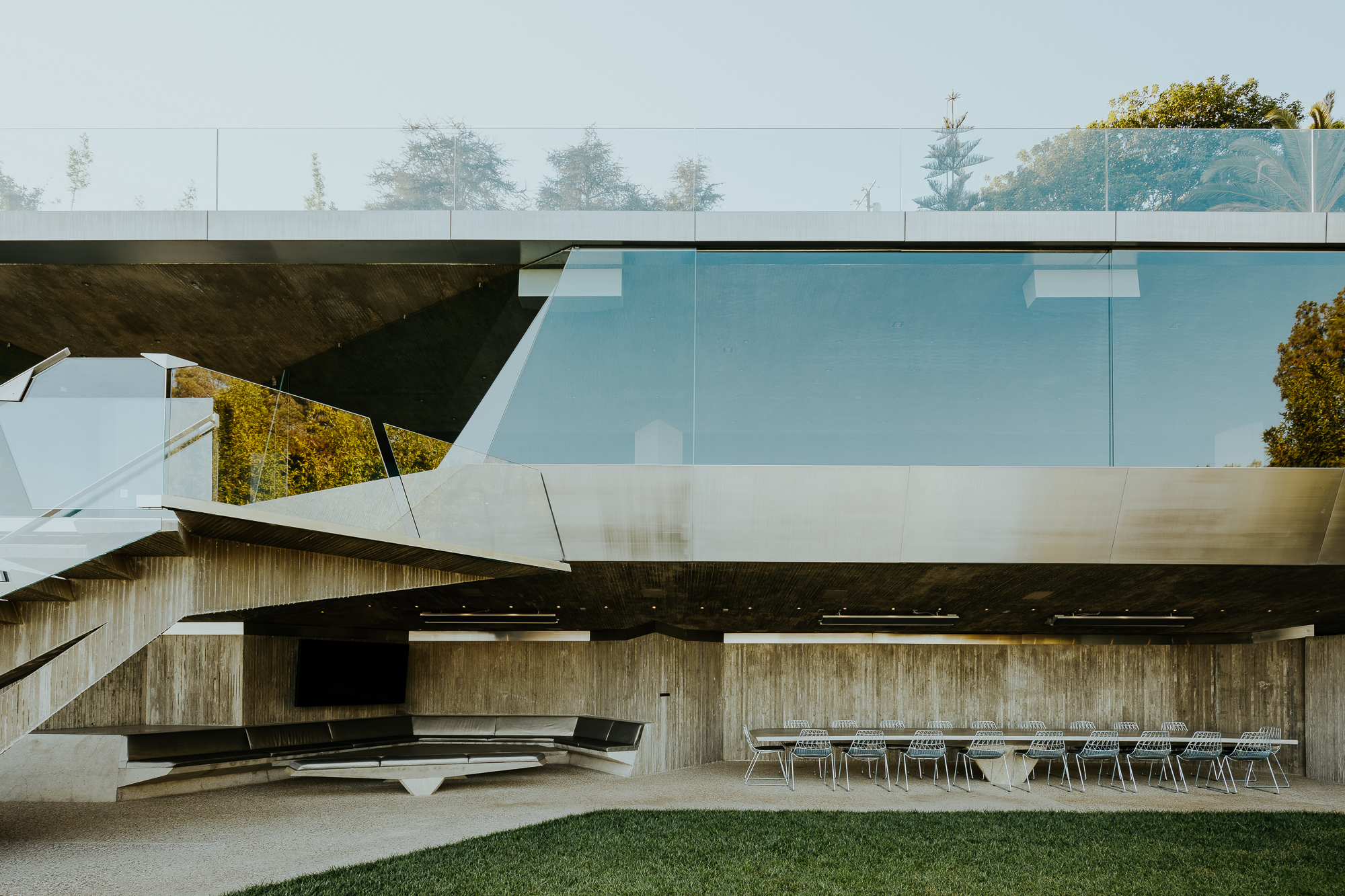 Sheats-Goldstein Residence in LA with its concrete sloped roof, pool and green open grounds