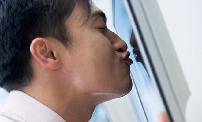 Guy kissing computer