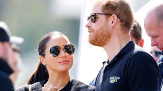 Meghan, Duchess of Sussex and Prince Harry, Duke of Sussex watch the Land Rover Driving Challenge, on day 1 of the Invictus Games 2020 at Zuiderpark on April 16, 2022 in The Hague, Netherlands. (Photo by Max Mumby/Indigo/Getty Images)