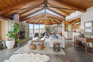 Kim Novak's house rustic living room with stone fireplace