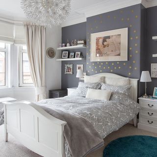 bedroom with grey wall and bedside table