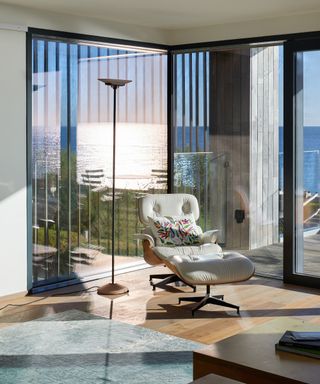 A swivel armchair in a living room with floor to ceiling glazing