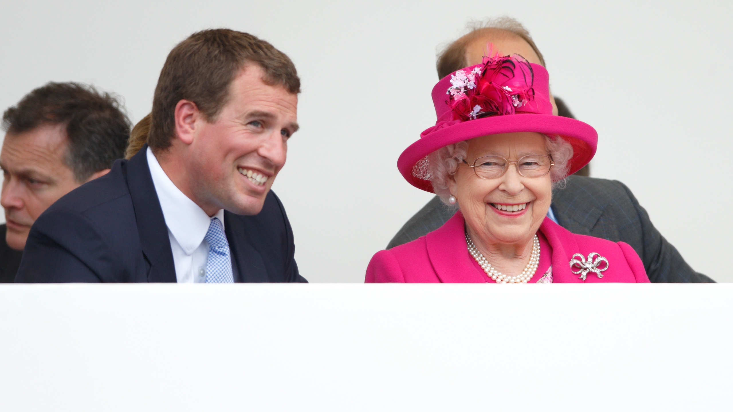 Peter Phillips and Queen Elizabeth II watch a carnival parade to mark Queen Elizabeth II's 90th birthday on The Mall on June 12, 2016