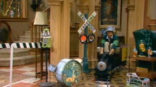 A cast member riding the mini train through the house in Silver Spoons