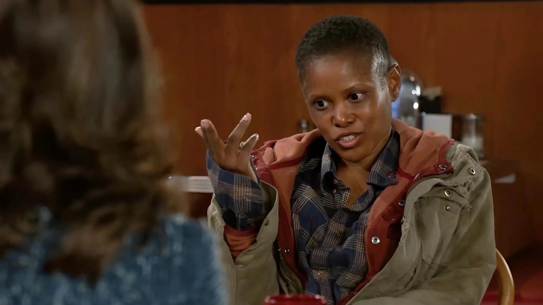 Jasmine Burke as June talking to someone in Beyond the Gates