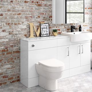 white bathroom with brick wall