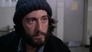 Al Pacino looking serious with a beard and a knitted hat on