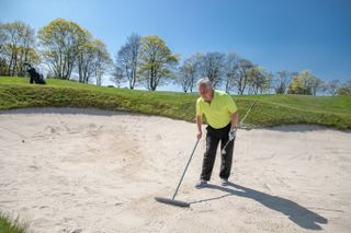Raking bunker to care for course