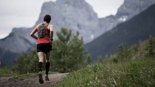 Trail runner in mountains wearing compression socks