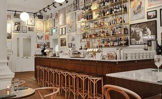 Bar and stools with multiple frames on walls