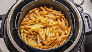 Instant Pot Duo Crisp and Air Fryer with cooked fries