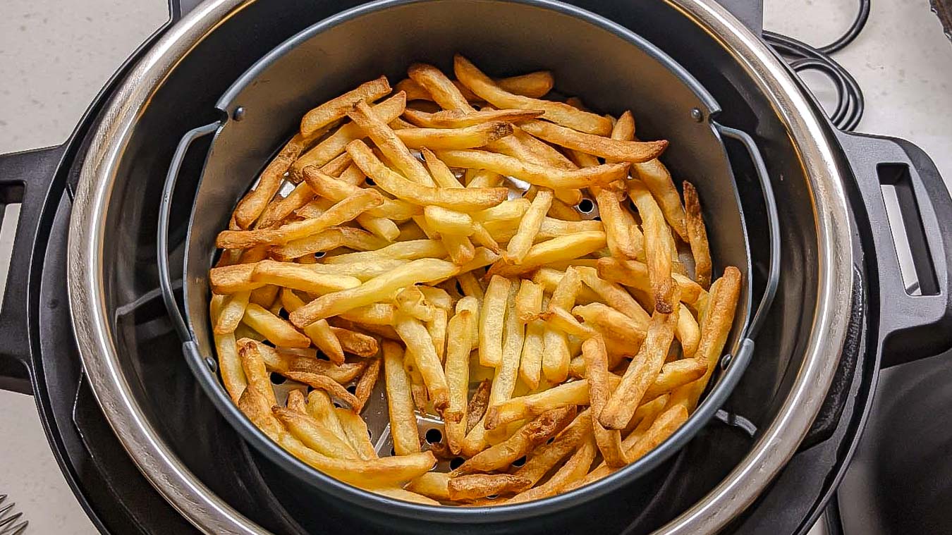 Instant Pot Duo Crisp and Air Fryer with cooked fries