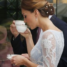 Kate Middleton drinking a cup of tea.