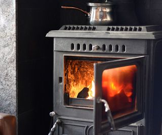 black log burning stove with fire burning