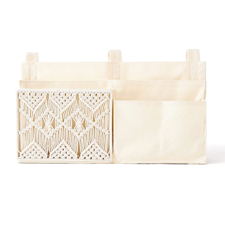 A cream-toned hanging bedside caddy with a macrame panel