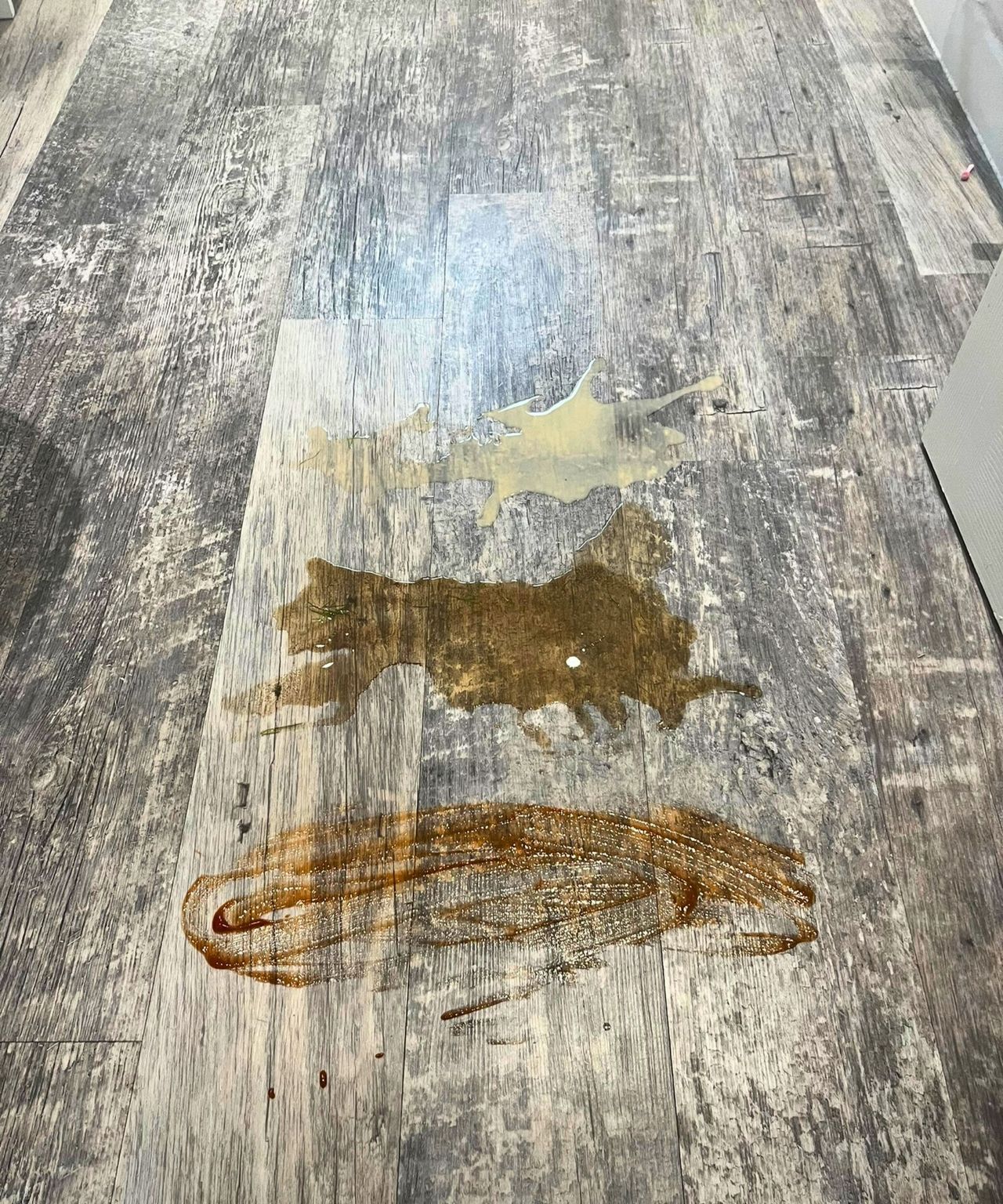 Spills on hardwood floor top to bottom showing milky coffee, muddy water and ketchup