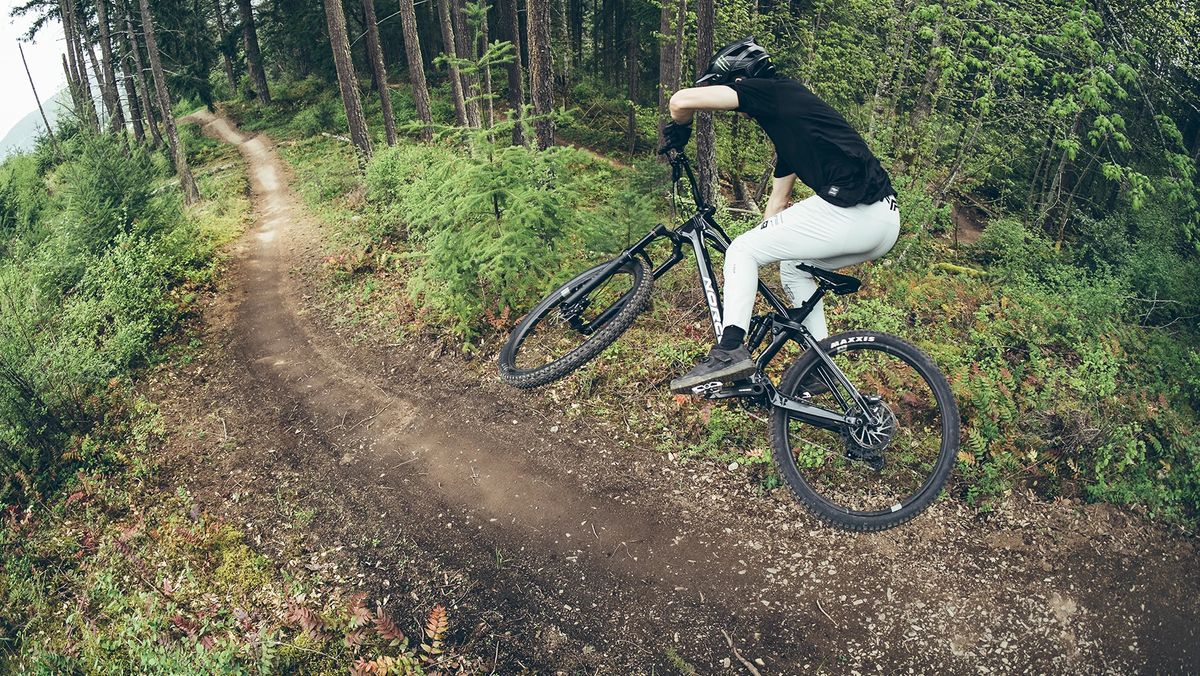 A mountain bike jumping down a trail