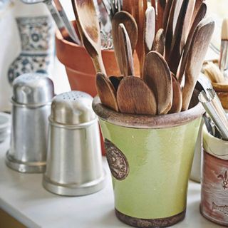 kitchen with recycled pots for spoon holder