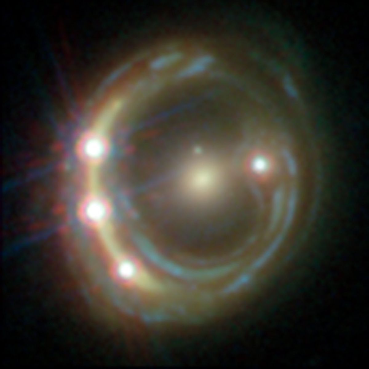 In this Hubble Space Telescope view of the distant quasar RXJ1131-1231, a foreground galaxy smears the image of the background quasar into a bright arc (left) and creates a total of four images — a phenomenon known as gravitational lensing. 