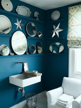 bathroom with dark blue walls and mirror display