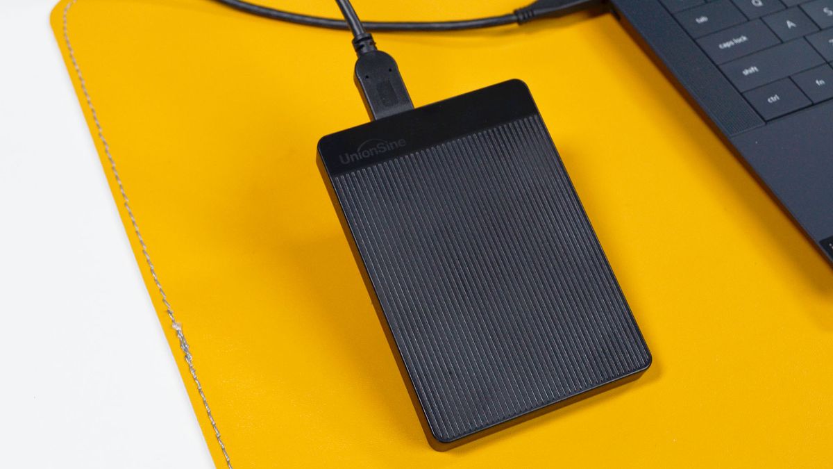 A UnionSine Ultra Slim external HDD on a desk with a laptop