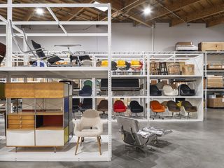 The Eames Institute of Infinite Curiosity Bay area headquarters and archive interior showing shelves of chair designs